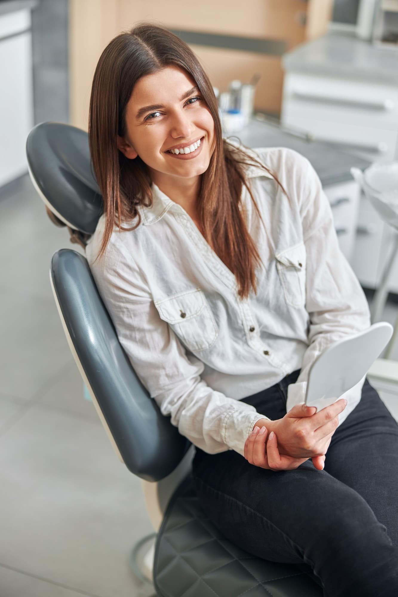 Schonsee Dental relaxed patient smiling during a checkup with dentist and assistant in Edmonton